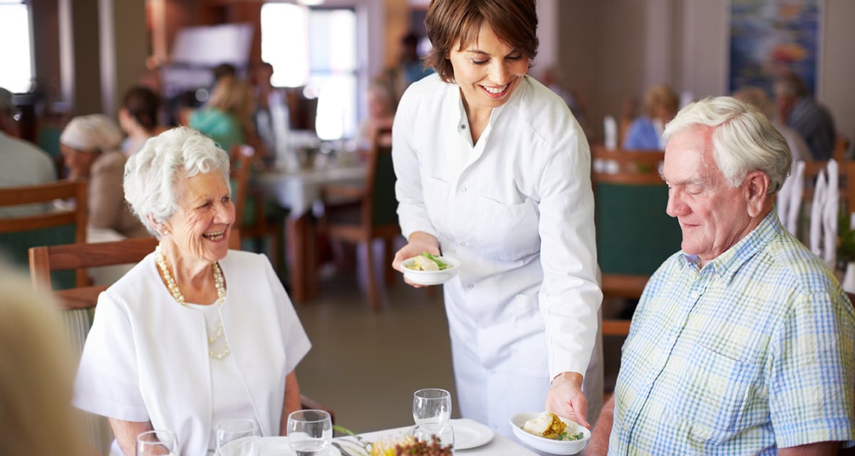 Couple being served food at table